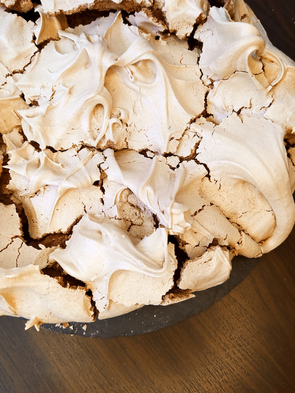 white icing covered cake on brown wooden table