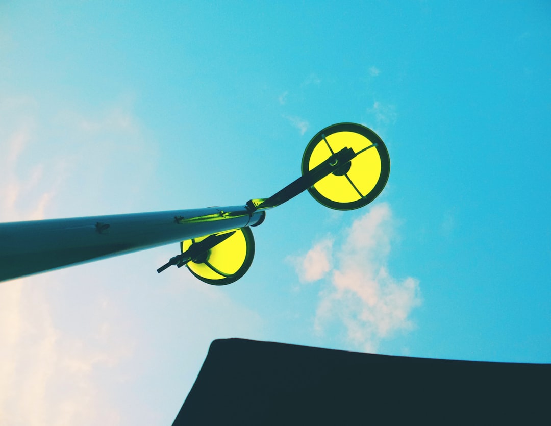 yellow and black plane in mid air during daytime