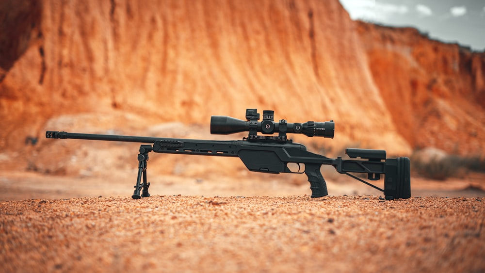 black rifle on brown sand