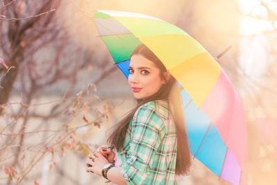 woman in red white and blue plaid dress shirt holding umbrella realistic google meet background