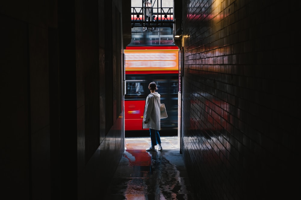 woman in white coat walking on hallway