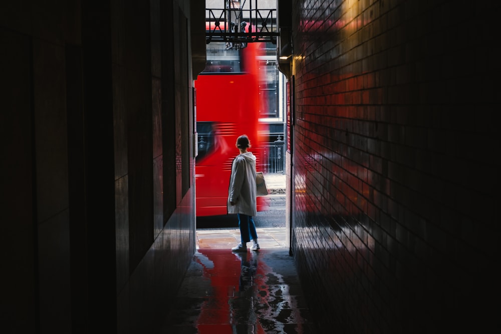 woman in white coat walking on hallway