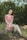 woman in red and white floral dress sitting on brown log