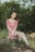 woman in red and white floral dress sitting on brown log