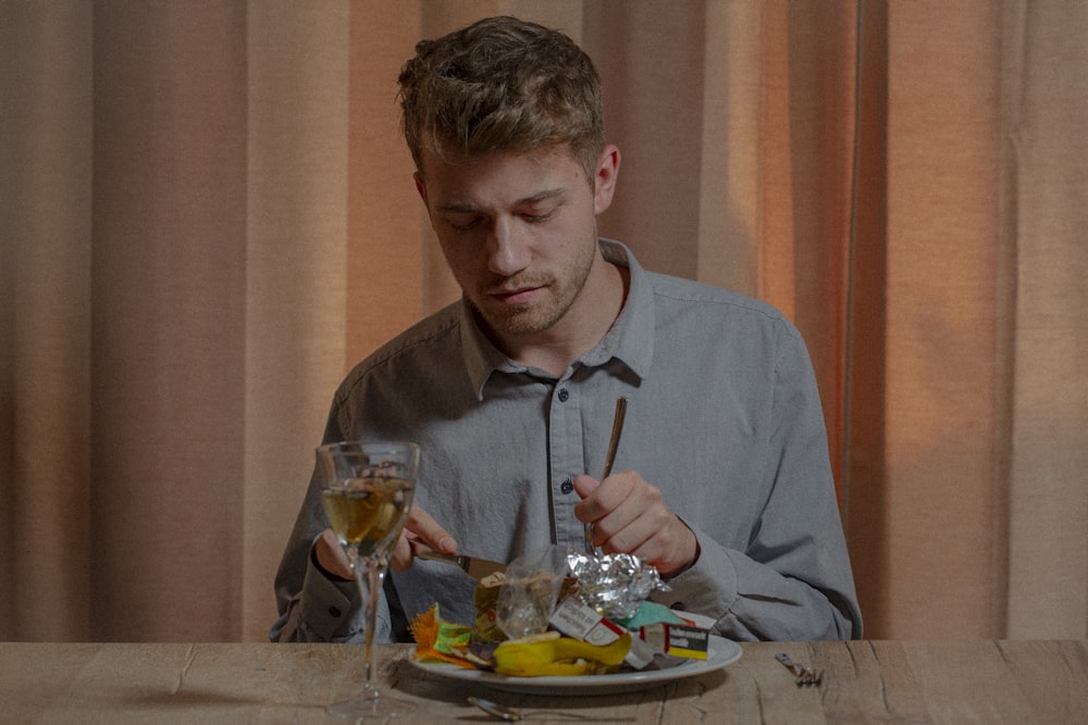 man in gray dress shirt sitting on chair