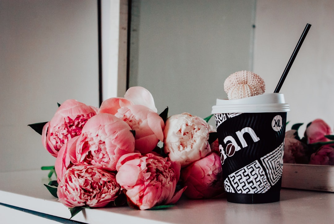 pink roses on black and white ceramic mug