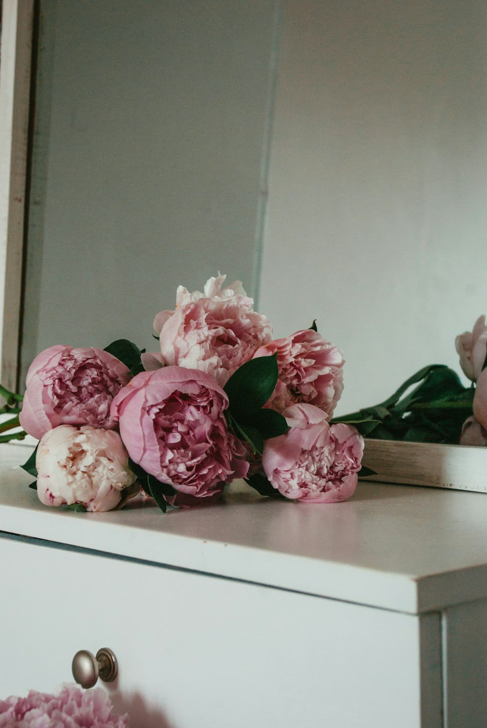 pink flower bouquet on brown wooden table