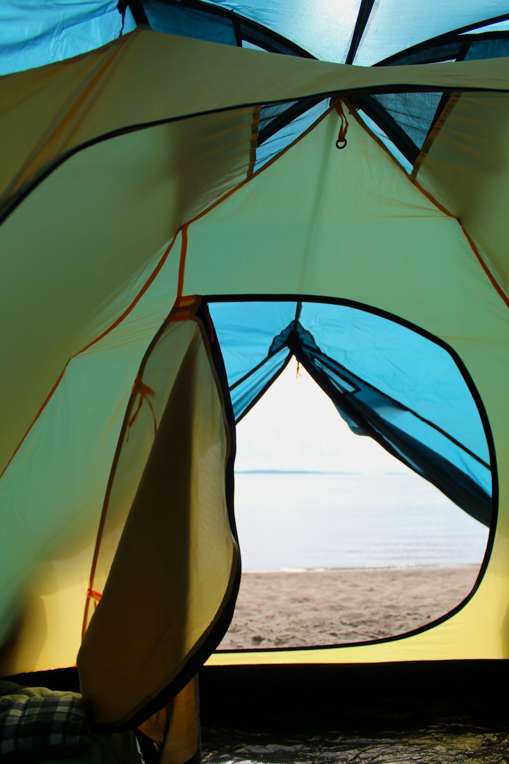 blue and white tent on beach during daytime