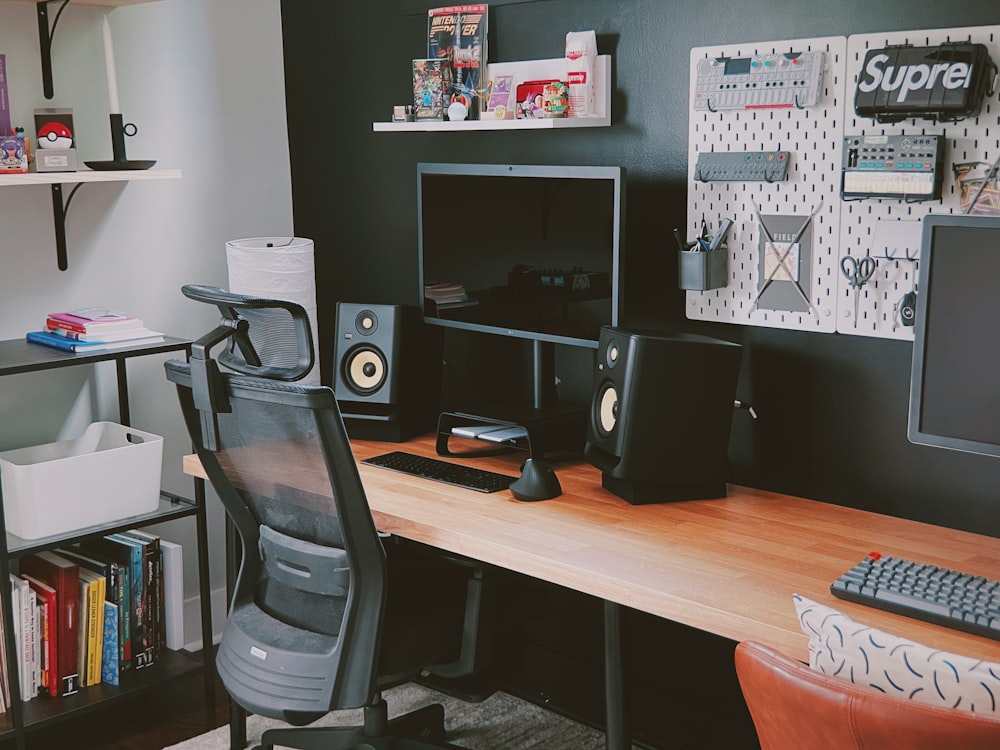 black flat screen computer monitor on brown wooden desk