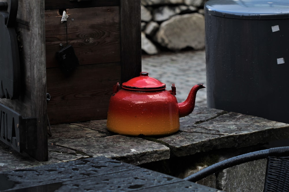 orange kettle on brown wooden table