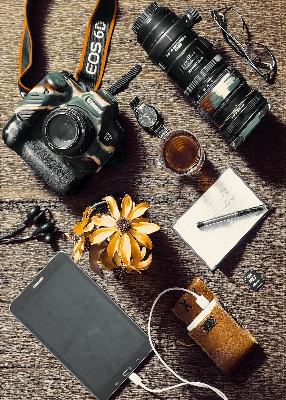 black and silver dslr camera on brown wooden table