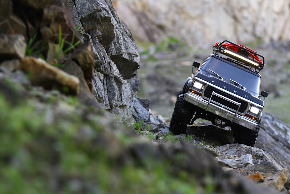 black jeep wrangler on rocky road during daytime