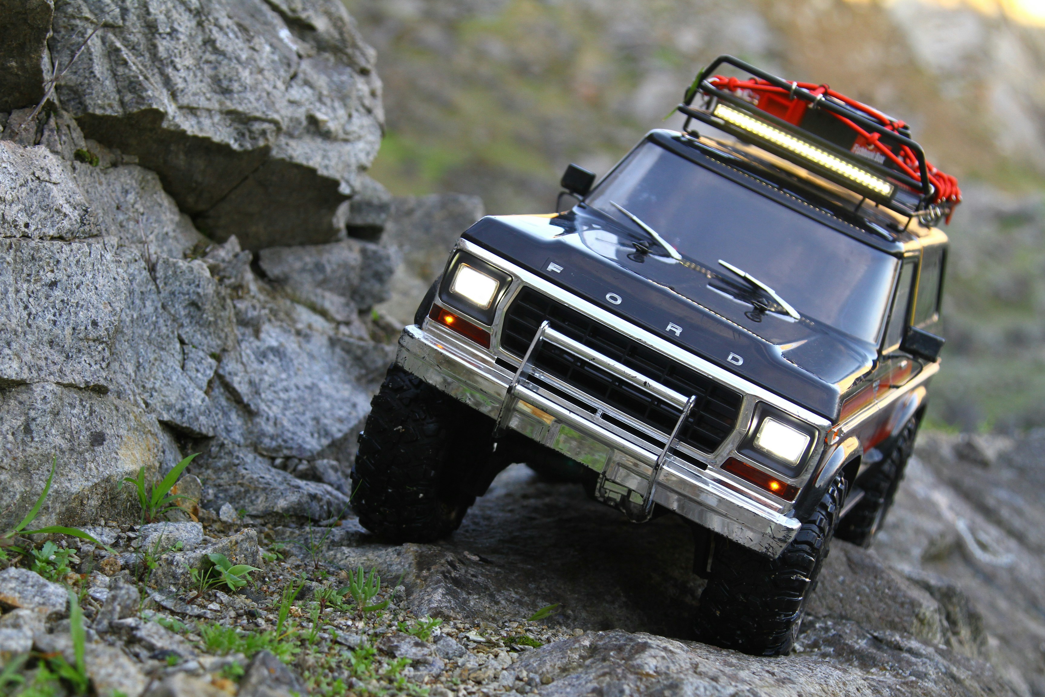 Orange RC Jeep on dirt