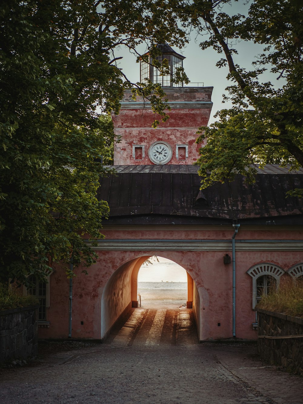 brown concrete arch with green trees