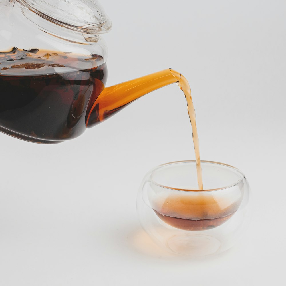 clear glass pitcher with black liquid