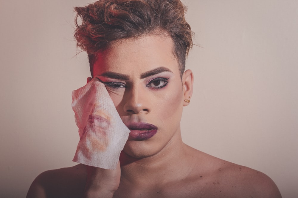 woman with white tissue paper on her face