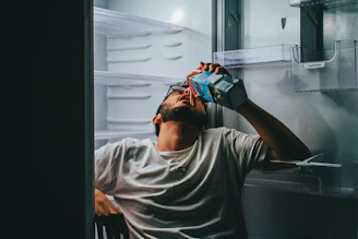 man in gray crew neck t-shirt holding blue and black box