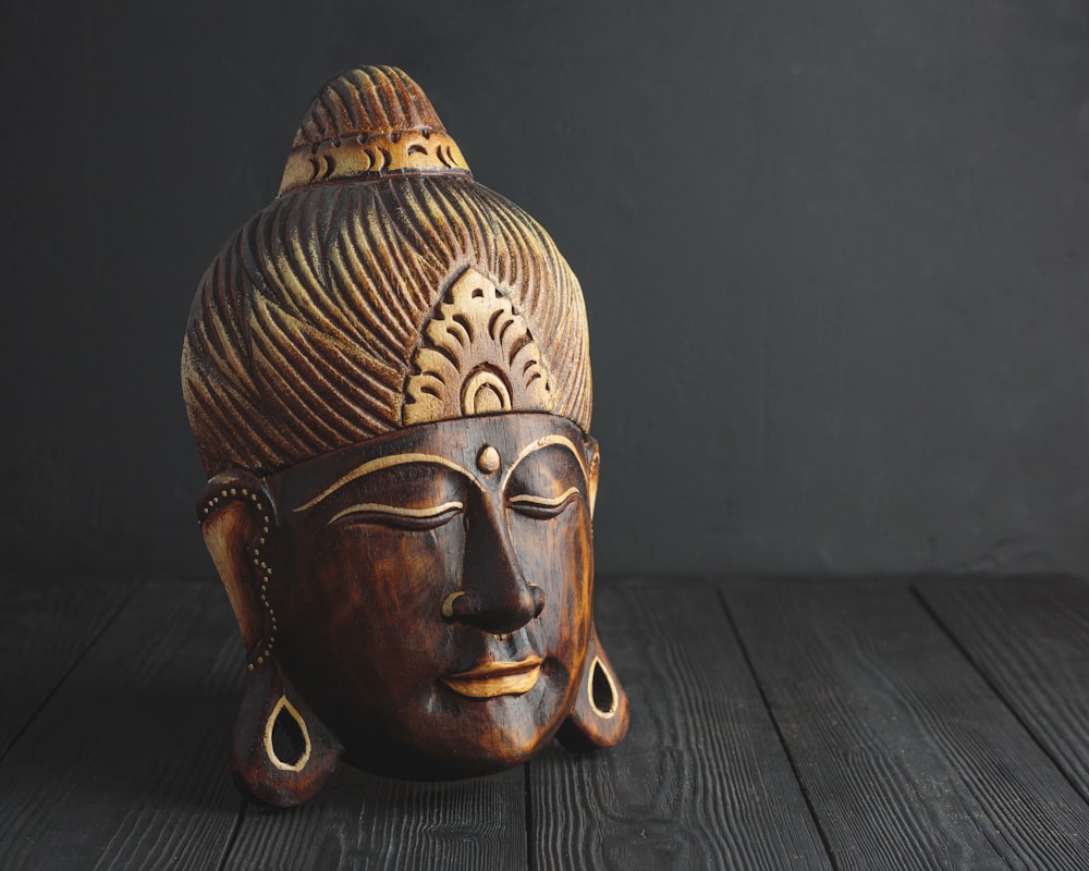 gold and brown wooden mask