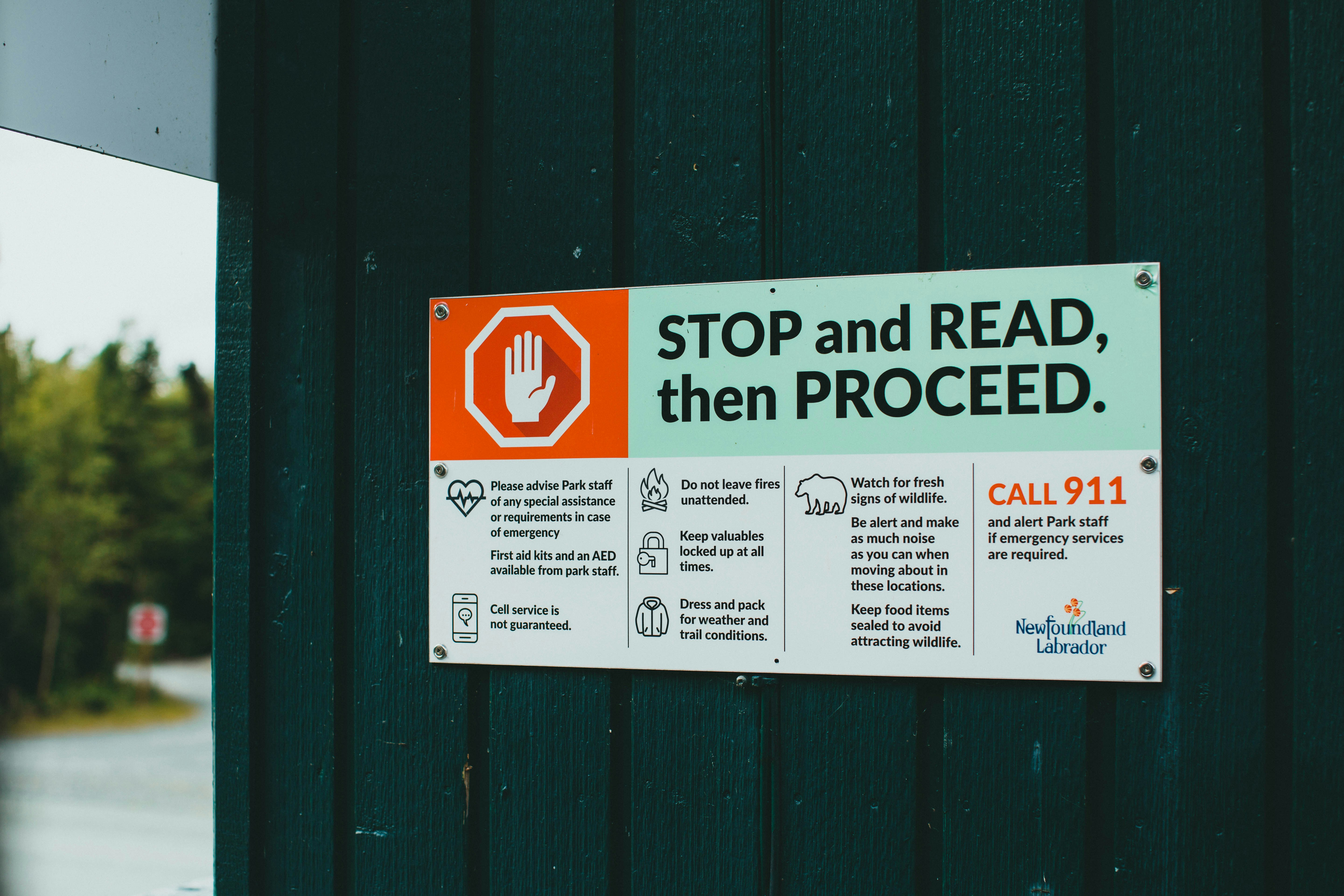 Children and a parent looking at a beach safety sign together