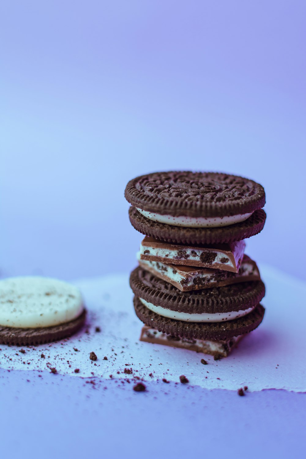 three chocolate cookies on white surface