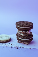 three chocolate cookies on white surface