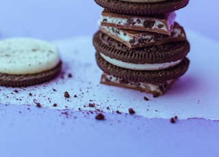 three chocolate cookies on white surface