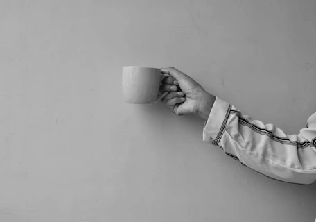 person holding white ceramic mug