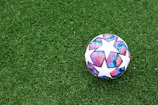 white blue and red soccer ball on green grass