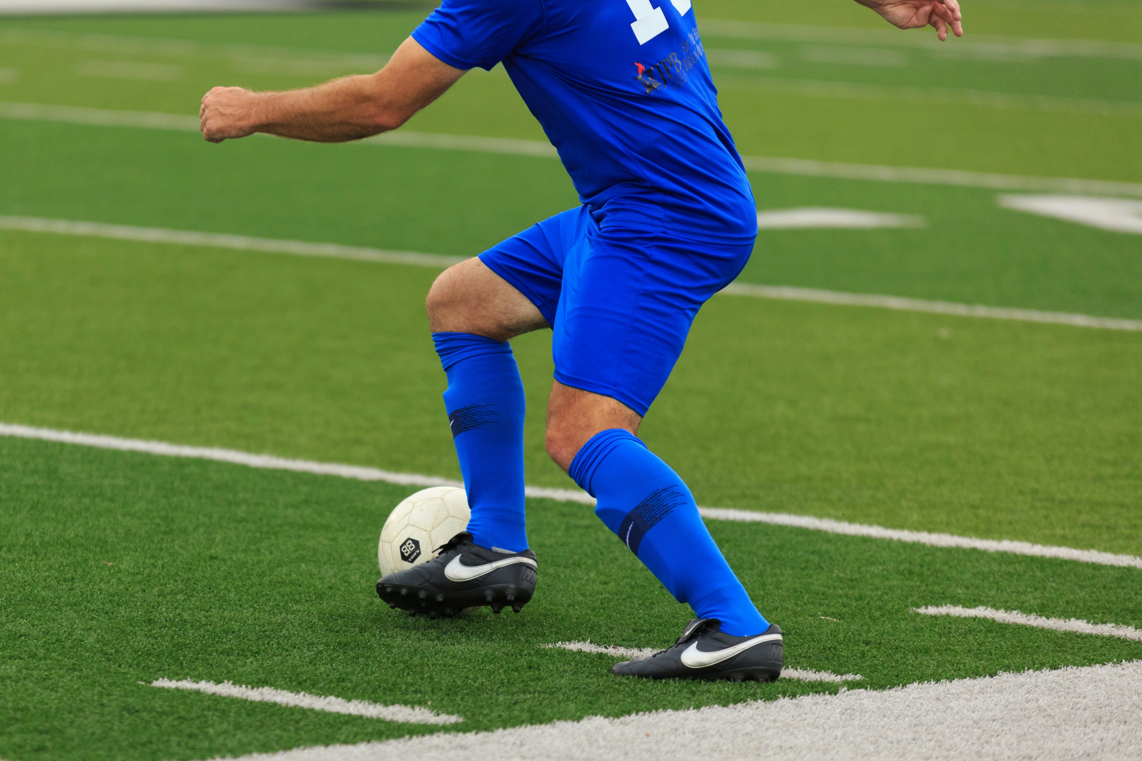 A soccer player attacks the ball.