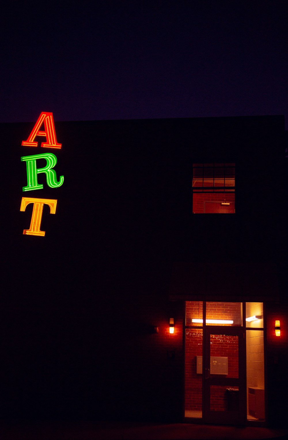 a neon sign on the side of a building