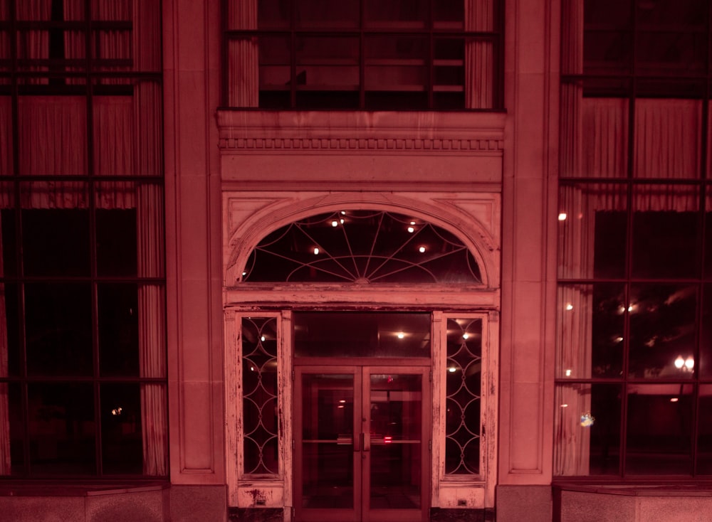 red wooden door with glass panel