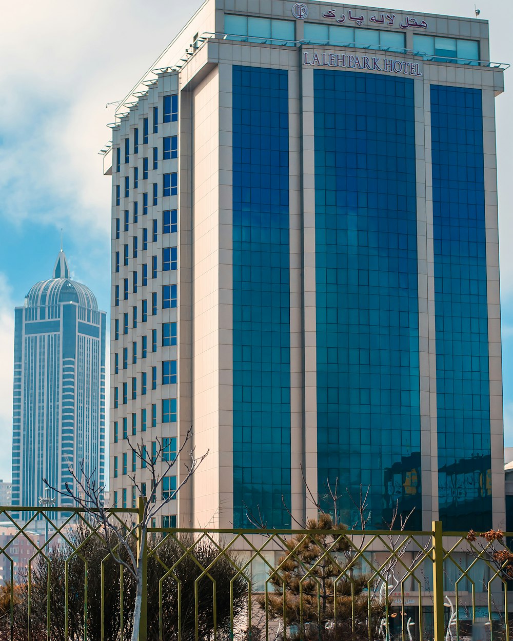 white concrete building under white clouds during daytime