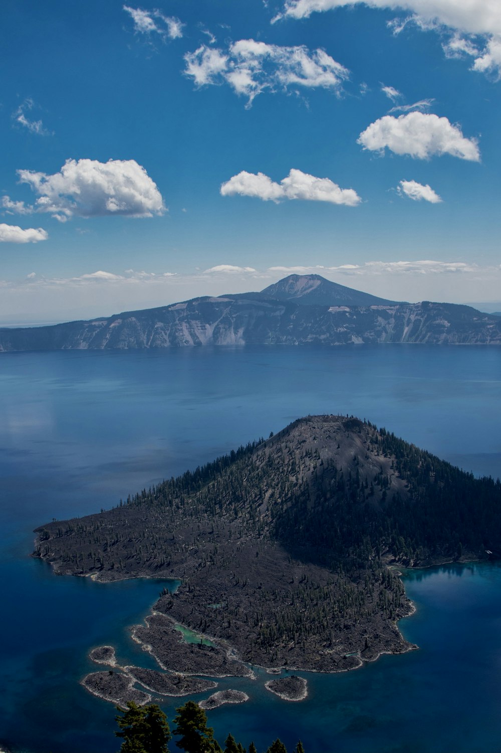 lake in the middle of mountains during daytime