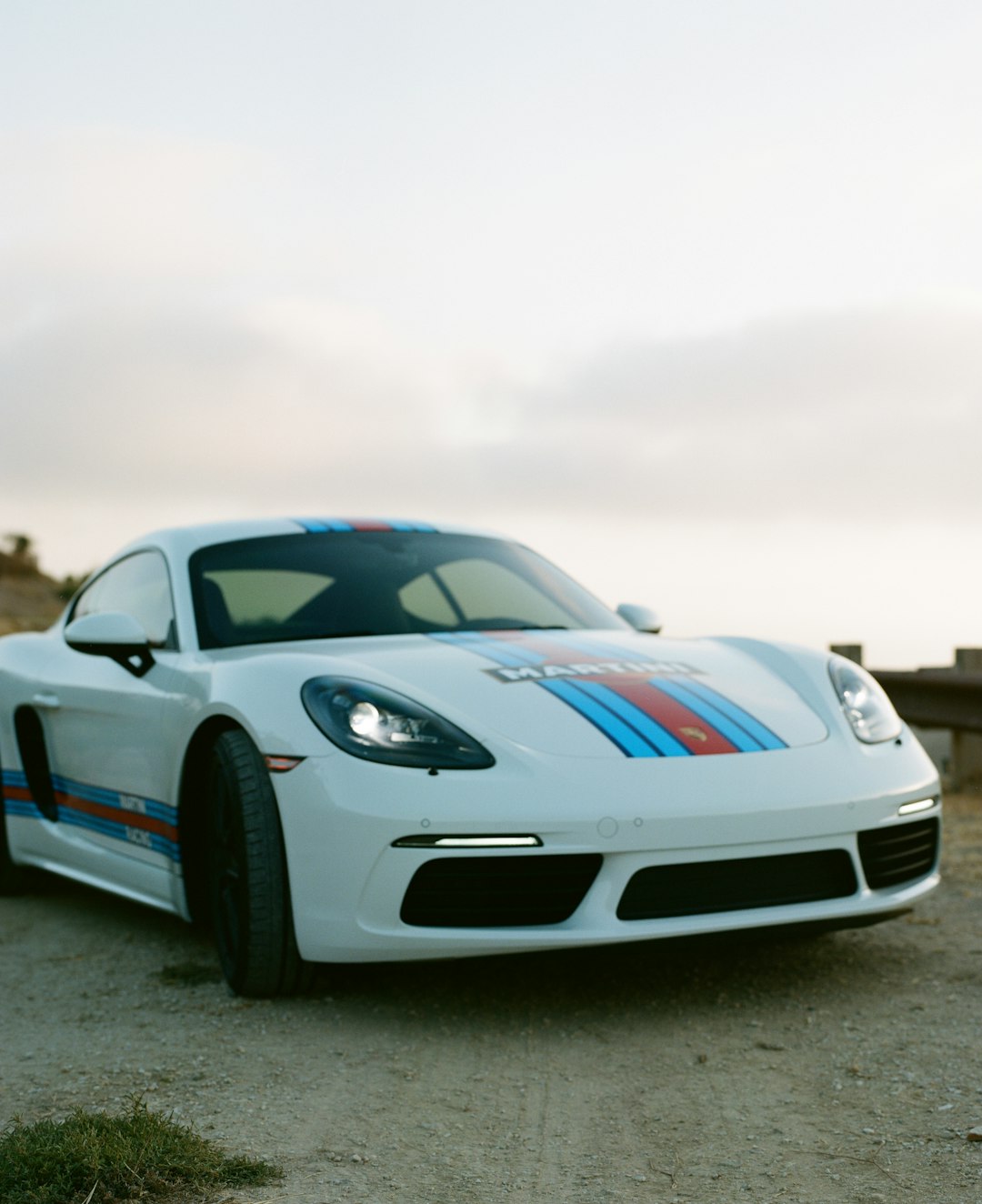 blue and white porsche 911 on gray asphalt road