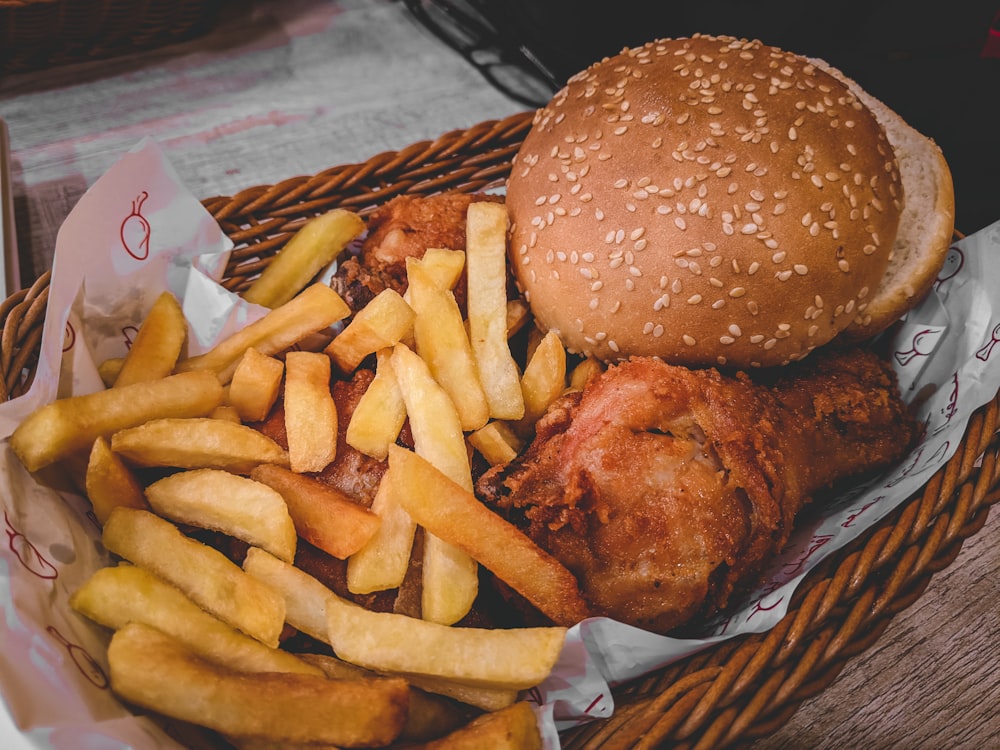 burger and fries on brown woven basket