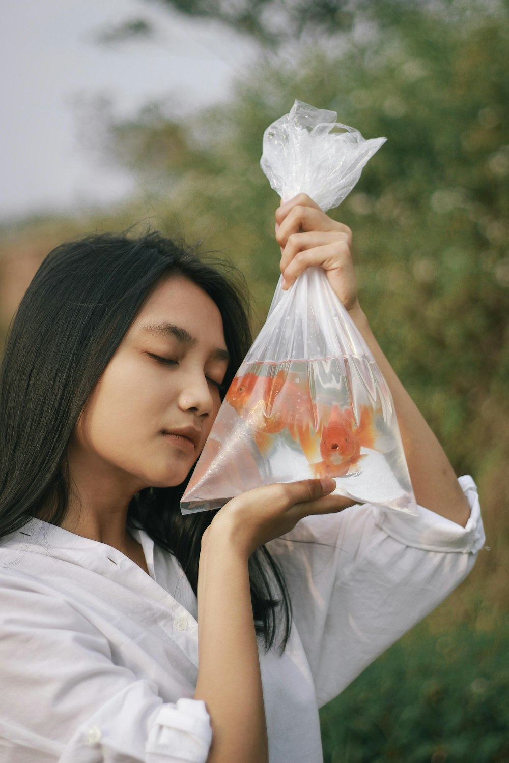 girl in white shirt holding white plastic bag