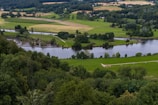 green grass field near lake during daytime