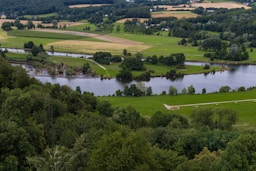 green grass field near lake during daytime