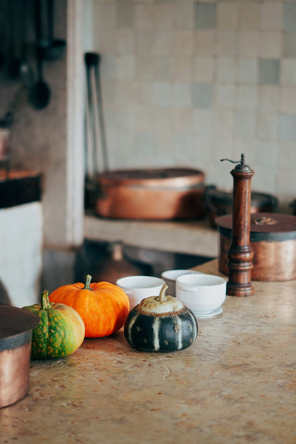 green pumpkin on brown wooden table