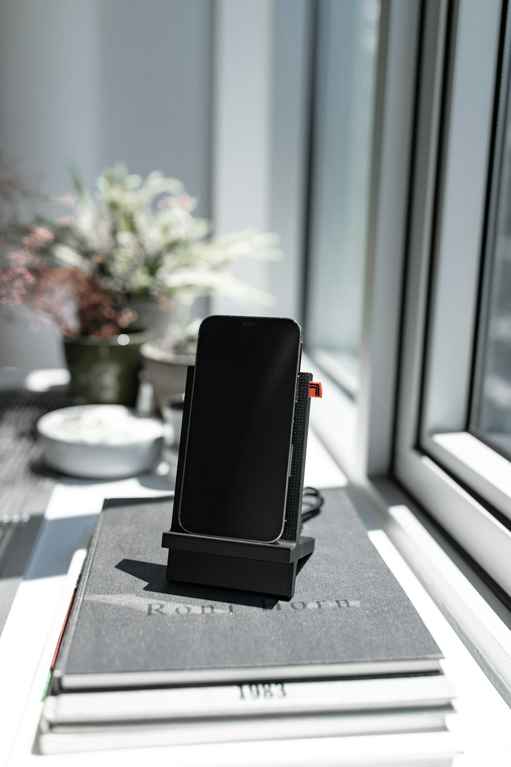 black smartphone on white table