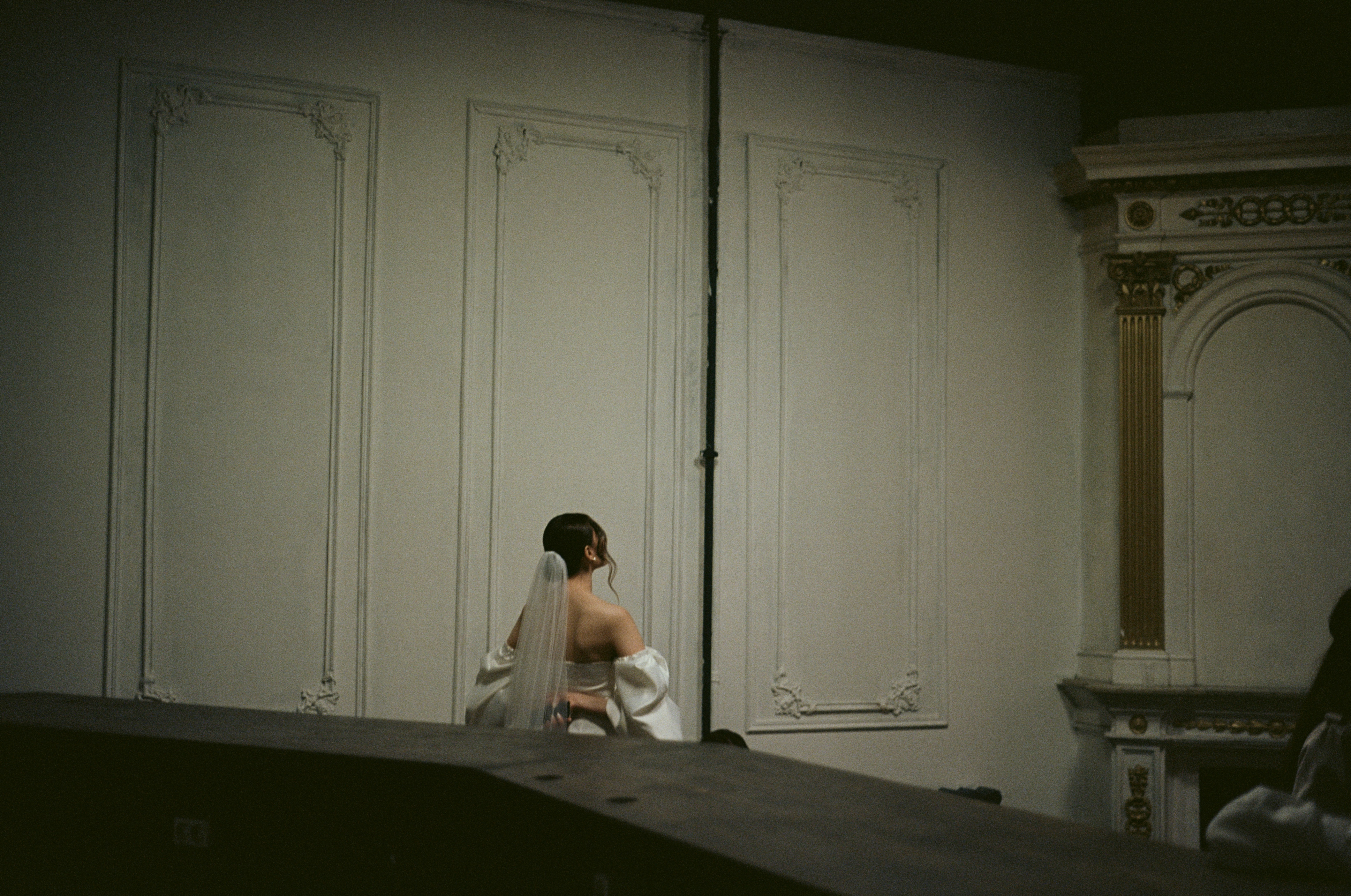 woman in white dress sitting on bed