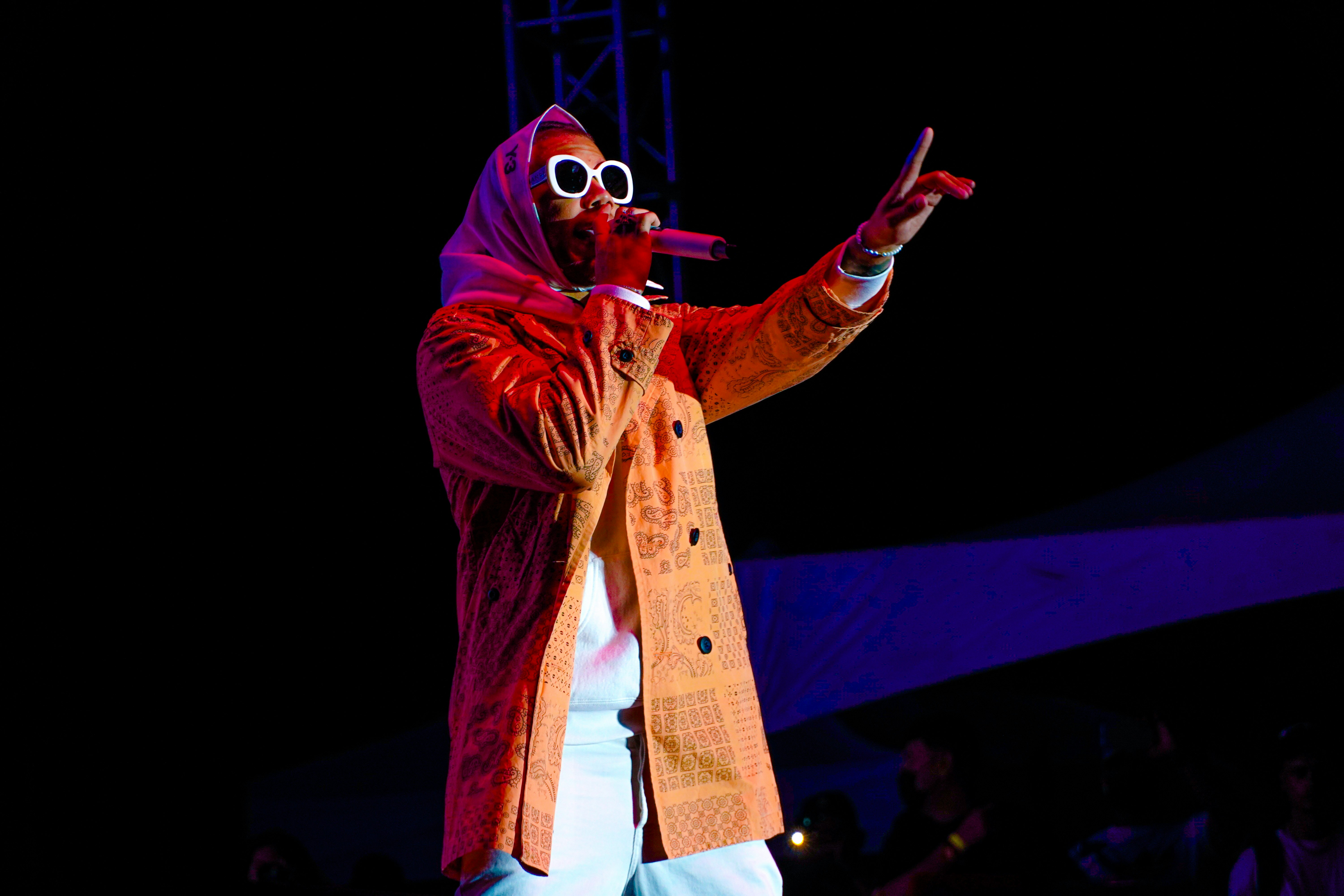 man in brown coat and white pants wearing white goggles