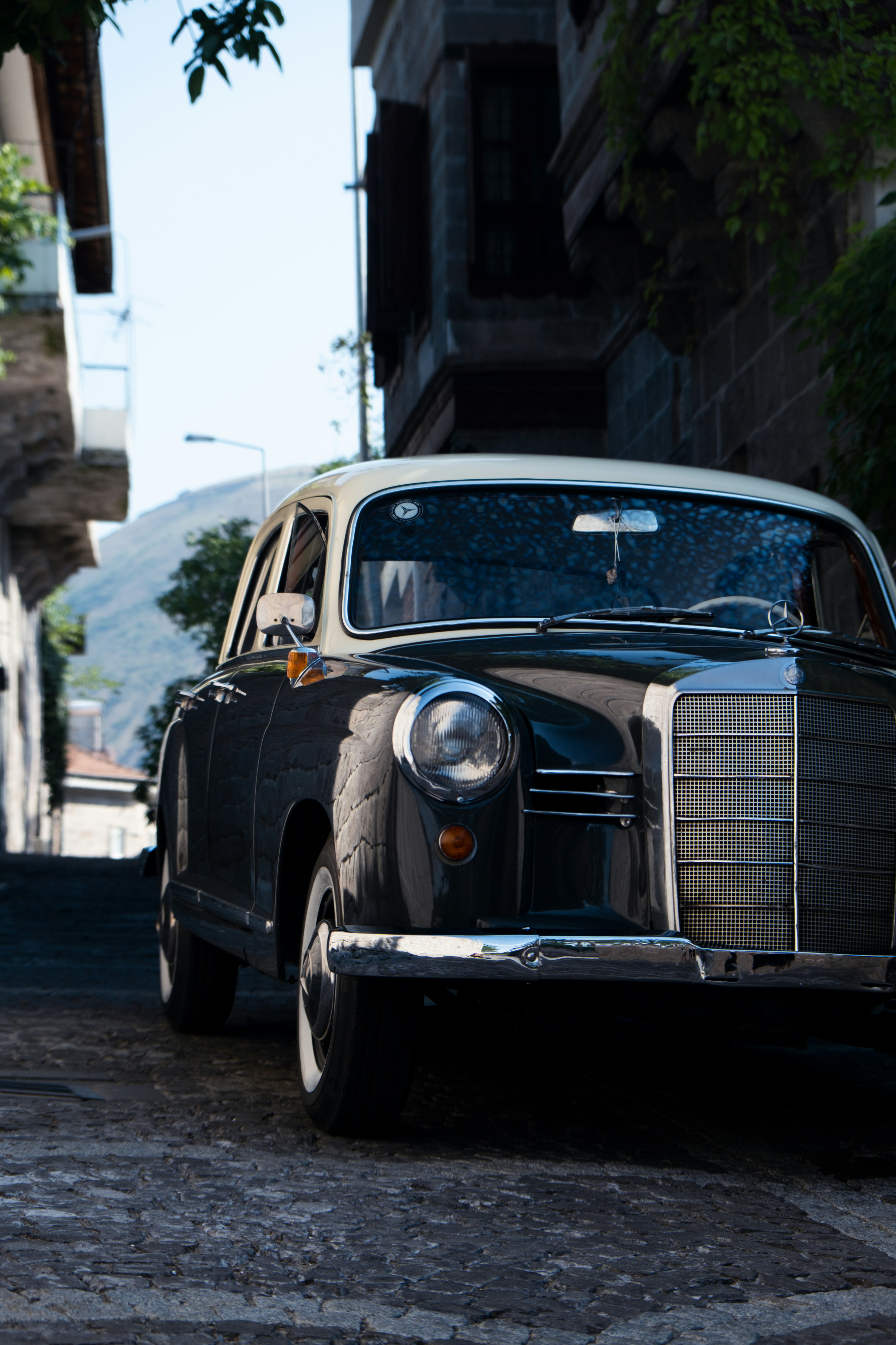 black car parked beside building during daytime