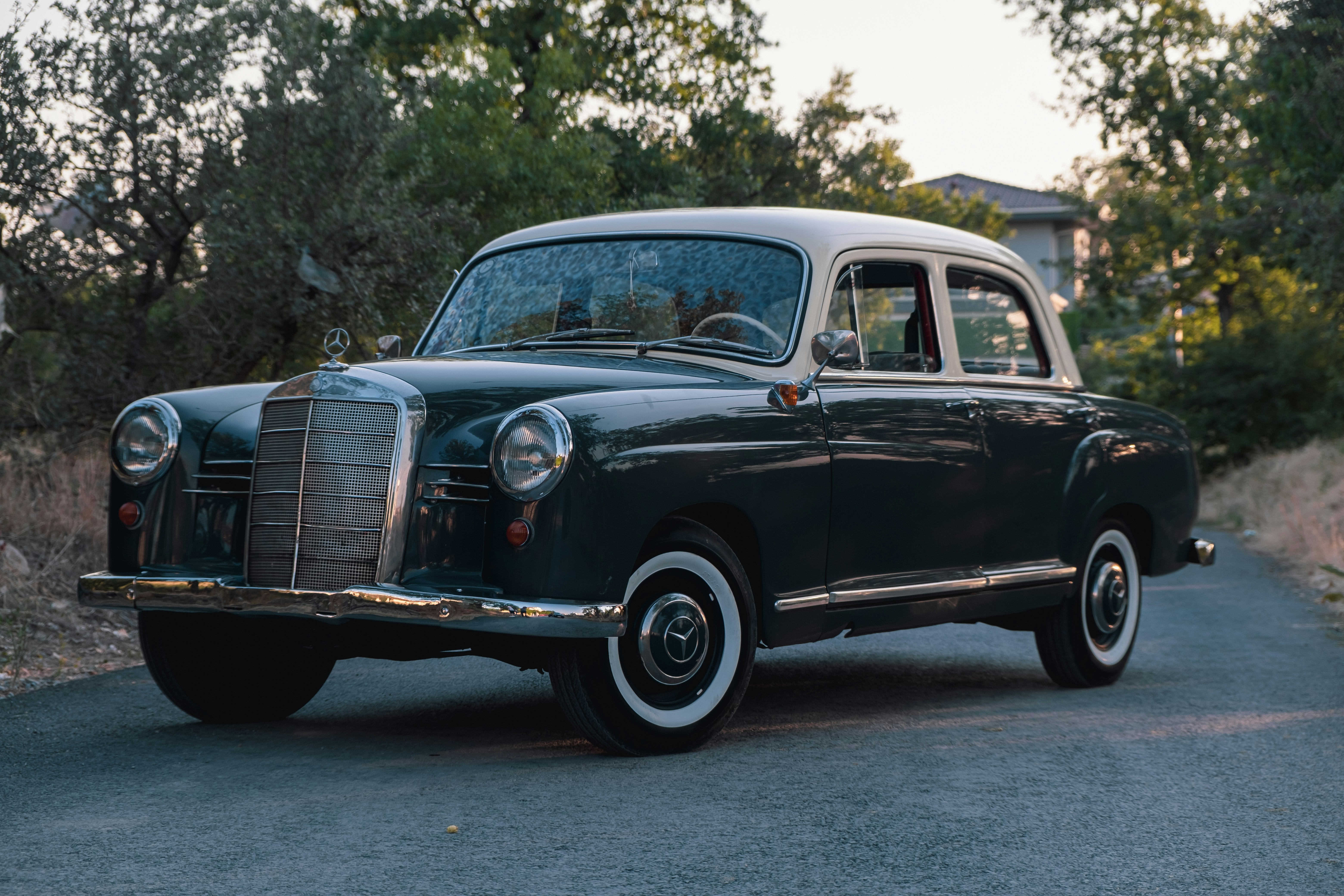 black vintage car on gray asphalt road during daytime