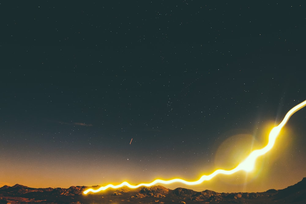 silhouette of mountain under starry night