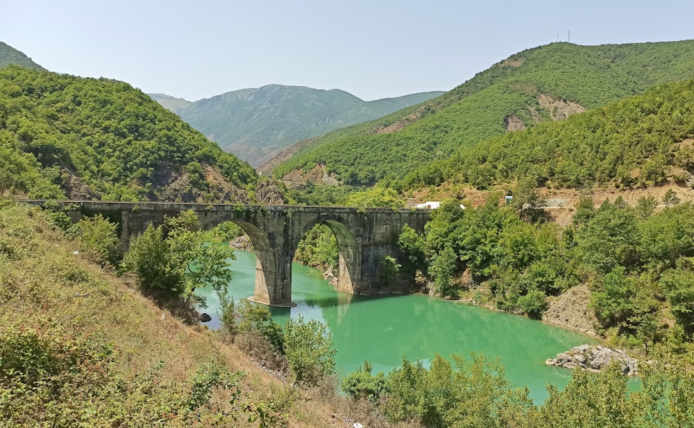 gray concrete bridge over river during daytime