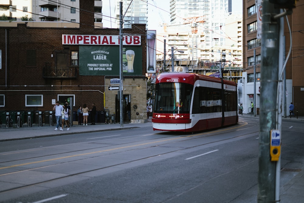 red and white tram on road during daytime