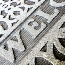 Close-up of a custom company logo doormat at an office entrance