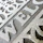 Close-up of a beautifully painted welcome mat with intricate floral designs at a front door.