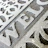 Close-up of a beautifully painted welcome mat with intricate floral designs at a front door.
